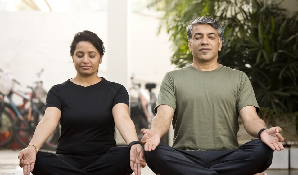 Two people doing yoga